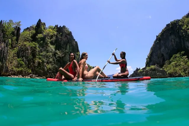 Tourists ride a paddle board at Cadlao Lagoon in El Nido, Palawan Islands, Philippines, 28 April 2018. According to reports, Philippine Senators Joseph Victor “JV” Ejercito and Juan “Sonny” Angara urged the Philippine government to promote other tourist destinations as the famous Boracay Island was closed for six months to tourists and non-residents for sanitation and development work, after the Philippines President Rodrigo Duterte labeled the island as a “cesspool” because of its water contamination. (Photo by Mark R. Cristino/EPA/EFE)