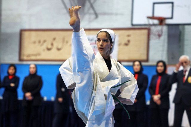 An Iranian athlete warms up prior to the start of the women's karate competition, made-up of clubs and teams from around the Tehran province, in Tehran on November 6, 2025. Some 230 participants, including 5-year-old girls, took part in the competition, with team's deriving only from the Tehran province taking part. (Photo by Atta Kenare/AFP Photo)