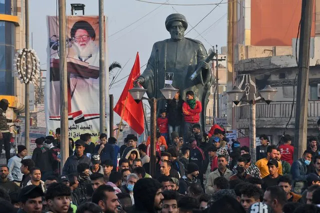 Iraqi protesters gather at al-Habboubi square in the southern city of Nasiriyah in Dhi Qar province on December 18, 2020, to demand their legitimate rights and accountability for killings. (Photo by Asaad Niazi/AFP Photo)