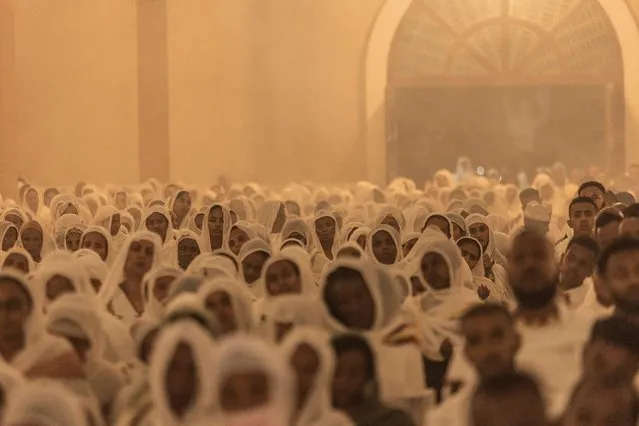 Ethiopian Orthodox devotees pray during the celebration of easter at Bole Medhanialem church in Addis Ababa, Ethiopia on April 16, 2023. Ethiopian Easter, also known as Fasika in Amharic, commemorates Jesus' resurrection and marks the end of a 55-day fast among Orthodox believers who did not consume meat. (Photo by Amanuel Sileshi/AFP Photo)