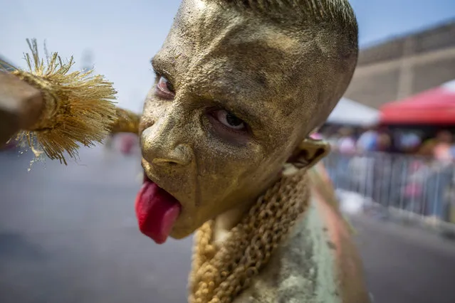 An artist gestures as he performs at Batalla de las Flores parade during the first day of the Barranquilla Carnival on March 26, 2022 in Barranquilla, Colombia. (Photo by Diego Cuevas/Getty Images)