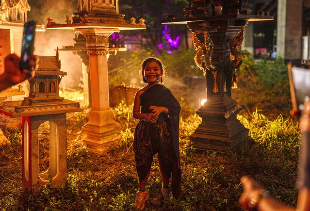 A girl wearing a Thai dress and Halloween makeup poses for photographs amidst decorations at Makkasan Train Factory in Bangkok on October 29, 2024. (Photo by Chanakarn Laosarakham/AFP Photo)
