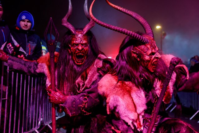 People dressed as the horned evil spirit known as the Krampus in Germany and Austria, and as the Parkeljni in Slovenia, parade through the small Slovenian town of Goricane, Slovenia on November 23, 2024. (Photo by Borut Zivulovic/Reuters)