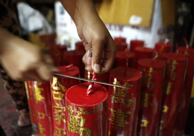 An Indonesian worker prepares candles at a traditional Chinese candle maker for the upcoming Lunar New Year in Bogor, Indonesia, 27 January  2015. (Photo by Adi Weda/EPA)