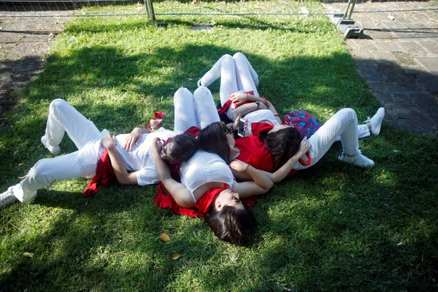 Revellers sleep in the park on the third day of the San Fermin festival in Pamplona, Spain July 8, 2018. (Photo by Joseba Etxaburu/Reuters)