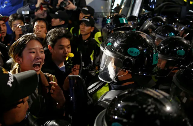 A demonstrator shouts to riot policemen who block protesters in a road nearby the presidential Blue House during the protesters' march calling South Korean President Park Geun-hye to step down in Seoul, South Korea, November 19, 2016. (Photo by Kim Hong-Ji/Reuters)