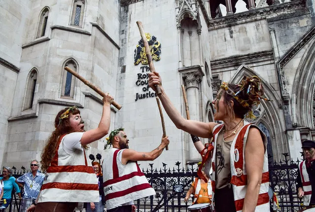 Protesters perform outside the Royal Courts of Justice in London on July 18, 2023, as the appeal against the Dartmoor camping ban gets underway. The appeal by Dartmoor National Park Authority aims to overturn an earlier ruling which prohibits wild camping in Dartmoor. (Photo by Vuk Valcic/ZUMA Press Wire/Alamy Live News)
