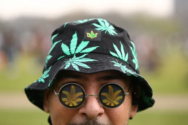 A man wearing accessories with cannabis leaf patterns attends a demonstration to mark the informal cannabis holiday, 4/20, in Hyde Park, London, Britain, April 20, 2021. (Photo by Tom Nicholson/Reuters)