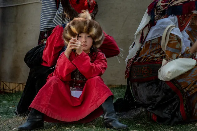 A young Kyrgyz girl wearing traditional dress watches over the activities and spectators at the World Nomad Games. (Photo by Eleanor Moseman/The Guardian)