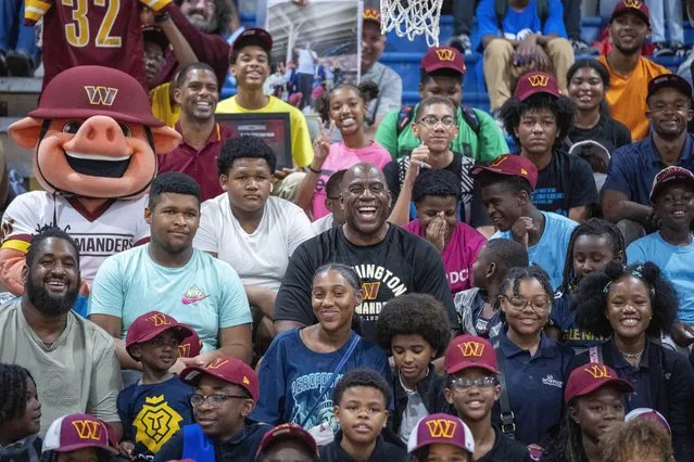 Washington Commanders part-owner Magic Johnson, center, poses for a photo in the stands with children at the Boys and Girls Club of Greater Washington, Thursday, September 7, 2023, in Washington. (Photo by Alex Brandon/AP Photo)