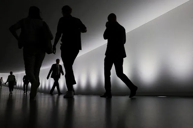 People walk through a tunnel to the lower house of parliament, Bundestag at the Reichstag building, in Berlin, Germany on September 20, 2023. (Photo by Fabrizio Bensch/Reuters)