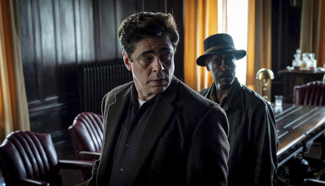 This image released by Warner Bros. Pictures shows Benicio del Toro, center, and Don Cheadle in a scene from “No Sudden Move”, a film that  will premiere as the centerpiece gala at the Tribeca Film Festival next month. (Photo by Claudette Barius/Warner Bros. Pictures via AP Photo)