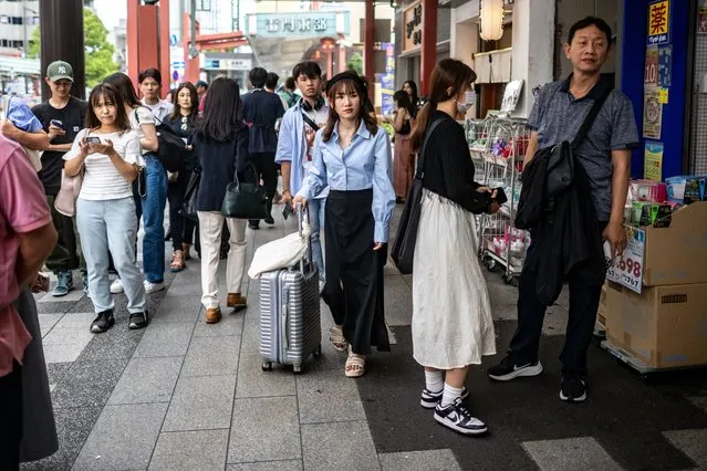 People visit Asakusa district near Sensoji Temple, a popular tourist location, in Tokyo on September 7, 2023. (Photo by Philip Fong/AFP Photo)