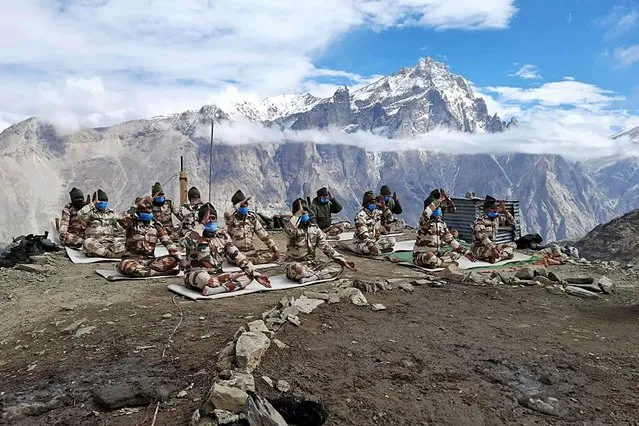 A handout photo made available by the Indo-Tibetan Border Police (ITBP) shows Indo-Tibetan Border Police officers performing yoga during the International Day of Yoga at a post in Himachal Pradesh, India, 21 June 2021. In December 2014, the United Nations (UN) declared 21 June as the International Day of Yoga after adopting a resolution proposed by Indian Prime Minister Narendra Modi. (Photo by Indo-Tibetan Border Police/Handout via EPA/EFE)