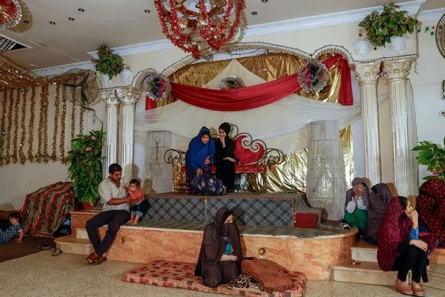 People rest as Palestinians, who fled their house amid Israeli strikes, shelter at a wedding hall after Israel's call for more than 1 million civilians in northern Gaza to move south, in Khan Younis in the southern Gaza Strip on October 19, 2023. (Photo by Ibraheem Abu Mustafa/Reuters)