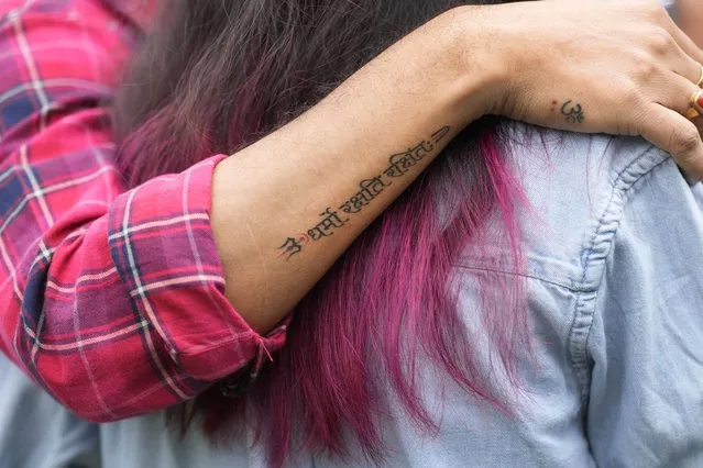 A LGBTQ+ community supporter sports a tattoo in Sanskrit that reads “Dharma protects those who protect it” after the Supreme Court refused to legalize same-s*x marriages, in New Delhi, Tuesday, October 17, 2023. (Photo by Manish Swarup/AP Photo)