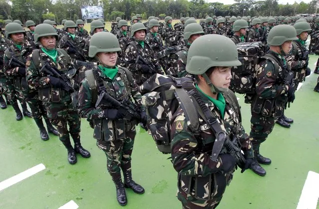 Troops stand at attention during the celebration of the 118th Founding Anniversary of the Philippine Army at the military headquarters in Fort Bonifacio, Taguig City, Metro Manila March 23, 2015. (Photo by Romeo Ranoco/Reuters)