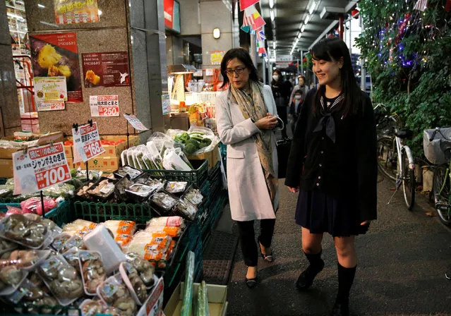 Chieko Shimada (L), 52, a mother of two daughters who runs a social security consulting company and her daughter Kaoruko Shimada, 19, a senior in high school who works part-time at a bakery, walk in front of a supermarket in Tokyo, Japan, November 29, 2016. (Photo by Toru Hanai/Reuters)