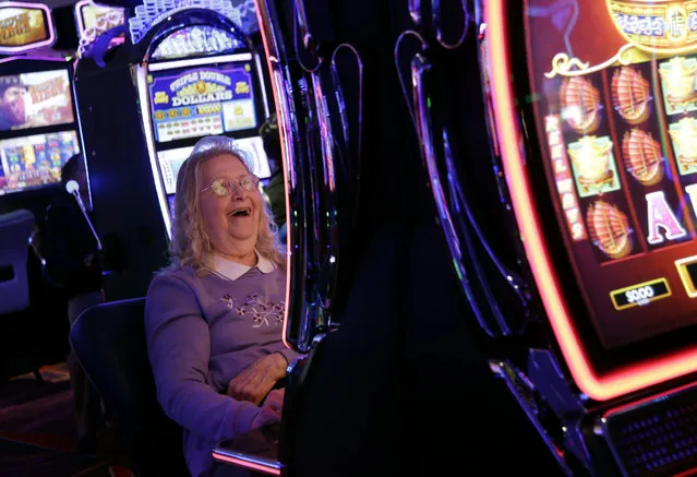 Helen Solcberg plays a video slot machine at the public opening of Resorts World Catskills in Monticello, N.Y., Thursday, February 8, 2018. The casino, in the heart of the old “Borscht Belt”, is being promoted as an economic boost to this historic resort area, but is opening in an increasingly competitive regional market. (Photo by Seth Wenig/AP Photo)