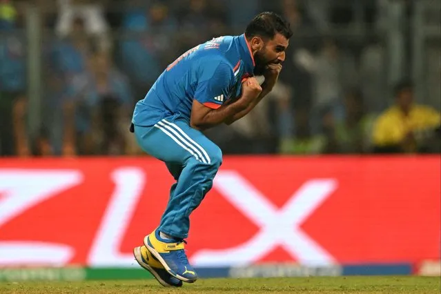 India's Mohammed Shami celebrates after taking the wicket of New Zealand's Tom Latham during the 2023 ICC Men's Cricket World Cup one-day international (ODI) first semi-final match between India and New Zealand at the Wankhede Stadium in Mumbai on November 15, 2023. (Photo by Punit Paranjpe/AFP Photo)
