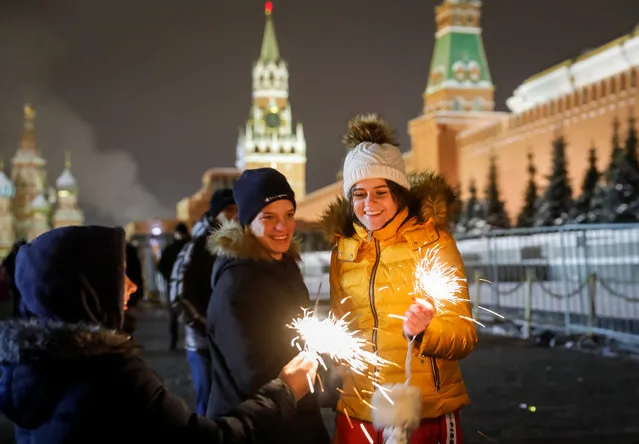 Revellers enjoy during New Year celebrations in Moscow's Red Square, Russia on December 31, 2018. (Photo by Tatyana Makeyeva/Reuters)