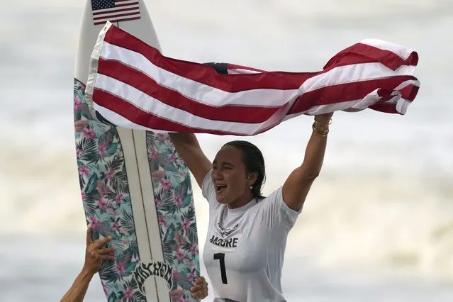 Carissa Moore, of the United States, celebrates winning the gold medal of the women's surfing competition at the 2020 Summer Olympics, Tuesday, July 27, 2021, at Tsurigasaki beach in Ichinomiya, Japan. (Photo by Francisco Seco/AP Photo)