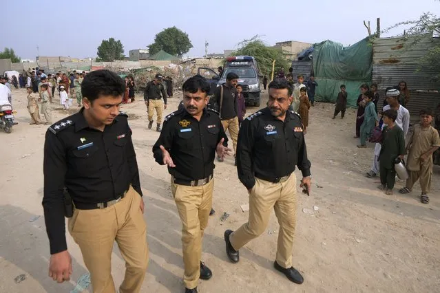 Police officers arrive to conduct a search operation against illegal immigrants, at a neighbourhood of Karachi, Pakistan, Tuesday, November 7, 2023. Pakistan government launched a crackdown on migrants living in the country illegally as a part of the new measure which mainly target all undocumented or unregistered foreigners. (Photo by Fareed Khan/AP Photo)