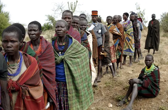 People from Karamojong tribe wait in line to vote at a polling station during elections in a village near the town of Kaabong in Karamoja region, Uganda February 18, 2016. (Photo by Goran Tomasevic/Reuters)