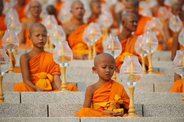 A young Buddhist monk prays at Wat Phra Dhammakaya during a ceremony on Makha Bucha Day in Pathum Thani province, north of Bangkok February 22, 2016. (Photo by Jorge Silva/Reuters)