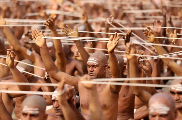 Newly initiated Naga Sadhus or Hindu holy men of the Juna Akhara attend the Dikasha ritual on the banks of the river Ganges during the ongoing “Kumbh Mela”, or the Pitcher Festival, in Prayagraj, previously known as Allahabad, India, February 6, 2019. (Photo by Jitendra Prakash/Reuters)