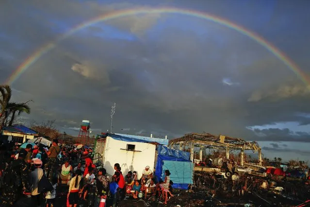 A rainbow appears above Typhoon Haiyan survivors desperate to catch a flight from the Tacloban airport November 15, 2013. (Photo by Damir Sagolj/Reuters)