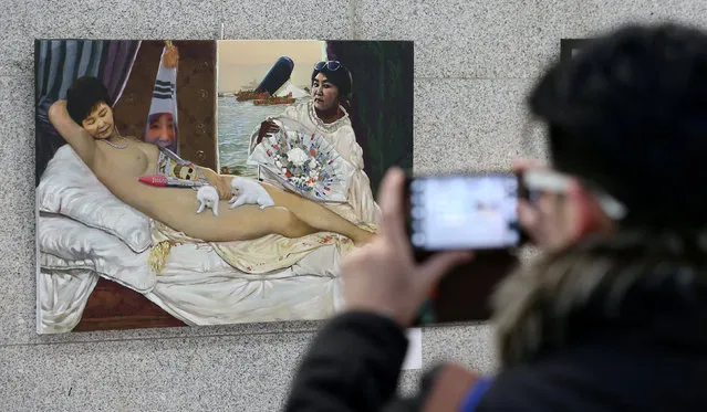A man takes photographs of a painting titled “Dirty Sleep” at the National Assembly in Seoul, South Korea, January 24, 2017. (Photo by Son Hyung-ju/Reuters/News1)