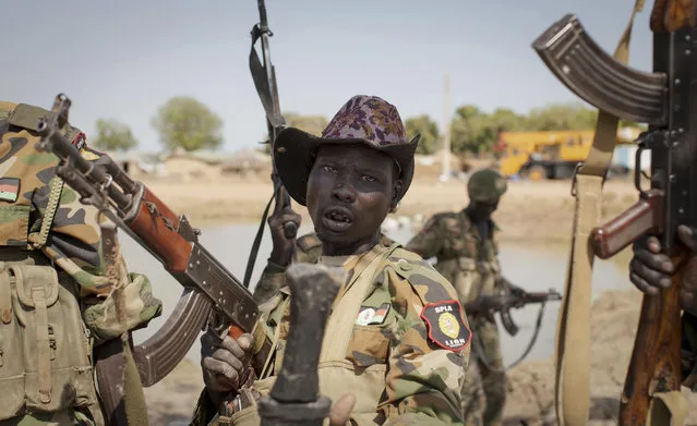 A South Sudanese government soldier chants in celebration after government forces on Friday retook from rebel forces the provincial capital of Bentiu, in Unity State, South Sudan, Sunday, January 12, 2014. (Photo by Mackenzie Knowles-Coursin/AP Photo)