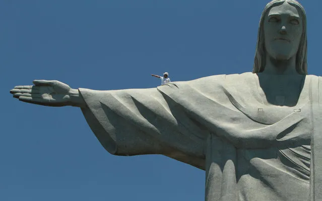 A worker inspects the Christ the Redeemer statue which was damaged during lightning storms in Rio de Janeiro January 21, 2014. (Photo by Levy Ribeiro/Brazil Photo Press/Agência o Dia)