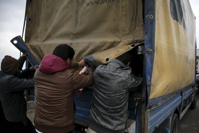 Refugees and migrants grab goods donated by volunteers from a truck at a makeshift camp at the Greek-Macedonian border, near the village of Idomeni, Greece March 16, 2016. (Photo by Alkis Konstantinidis/Reuters)