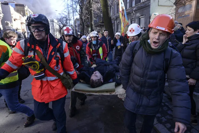 An Interior Ministry member, who was injured during clashes with anti-government protesters, is transported on a stretcher in Kiev. (Photo by Andrew Kravchenko/Reuters)