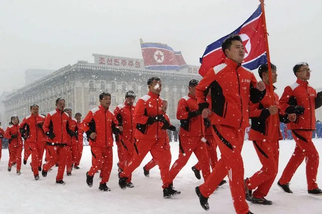 North Korea's officials of commissions, ministries and national institutions run at Kim Il Sung Square on the first sports day of the New Year in Pyongyang, North Korea, Sunday, January 14, 2024. (Photo by Cha Song Ho/AP Photo)