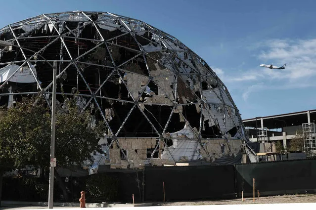 A large dome used as a studio production facility near the Burbank Airport is shredded from strong winds that passed through the area on Friday, November 26, 2021 in Burbank, Calif. Santa Ana winds were declining in strength Friday but thousands of Southern California utility customers remained without electricity due to intentional power shutoffs intended to prevent wildfires. (Photo by Richard Vogel/AP Photo)