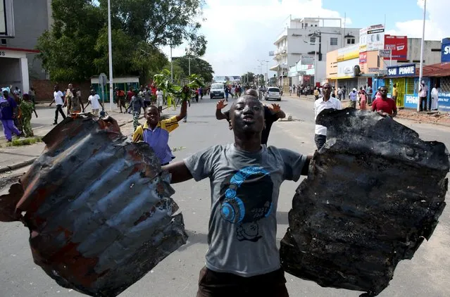 A man celebrates in a street in Bujumbura, Burundi, May 13, 2015. (Photo by Goran Tomasevic/Reuters)