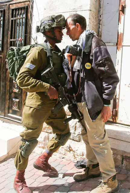 A foreign activist argues with an Israeli soldier during a protest in the West Bank city of Hebron February 24, 2017. (Photo by Mussa Qawasma/Reuters)