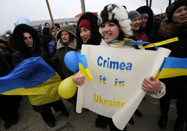 Crimean Tatars shout slogans during the pro-Ukraine rally in Simferopol, Crimea, Ukraine, Monday, March 10, 2014.  Russian President Vladimir Putin on Sunday defended the separatist drive in the disputed Crimean Peninsula as in keeping with international law, but Ukraine's prime minister vowed not to relinquish “a single centimeter” of his country's territory. The local parliament in Crimea has scheduled a referendum for next Sunday. (Photo by Darko Vojinovic/AP Photo)
