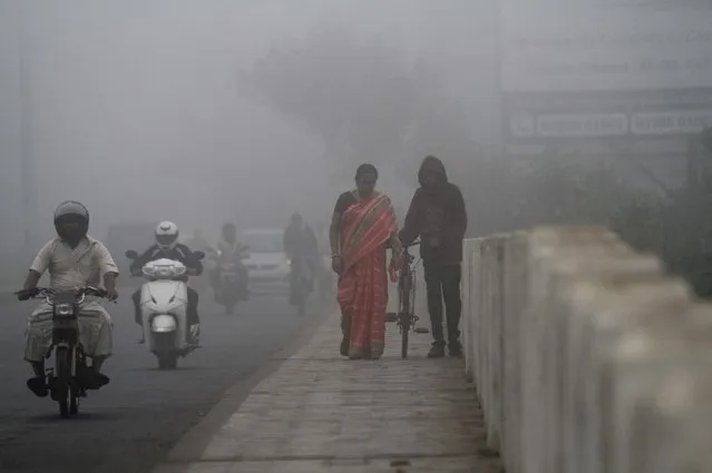 Local residents look in the todays morning foggy weather in the eastern Indian city Bhubaneswar, India, Saturday, 11 February 2017. Rail and air traffic affected due to heavy fog surrounded in eastern Indian. (Photo by STR/NurPhoto via Getty Images)