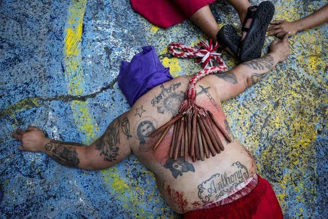A Filipino penitent lies on the ground while performing self-flagellation on Maundy Thursday in Mandaluyong City, Metro Manila, Philippines, on March 28, 2024. (Photo by Eloisa Lopez/Reuters)