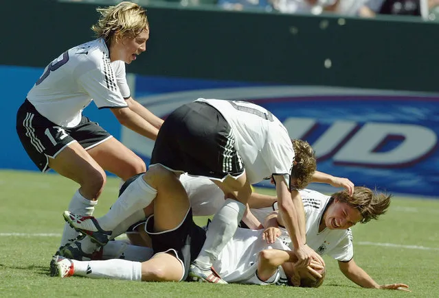 Nia Keuezer #4 of Germany (2nd R) and teammates celebrate her game winning goal over Sweden in the of the FIFA Women''s World Cup Final on October 12, 2003 at Home Depot Center in Carson, California. Germany defeated Sweden 2-1. (Photo by Al Bello/Getty Images)
