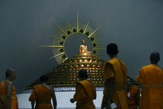 Thai Buddhist monks, representatives of the National Office of Buddhism (NOB), walk together during a search inside Wat Phra Dhammakaya Temple in Pathum Thani province, on the outskirts of Bangkok, Thailand, 10 March 2017. The National Office of Buddhism (NOB) of Thailand will meet with the Sangha Supreme Council on 10 March, for disciplinary action against Phra Dhammachayo, a former abbot of Dhammakaya Temple, who is charged with alleged land encroachment, money laundering and involvement in the Klongchan Credit Union Cooperative embezzlement scandal. The temple has been declared a special controlled area by the authorities. Phra Dhammachayo and the Dhammakaya Temple are being prosecuted on 346 legal cases by police, media reported. (Photo by Narong Sangnak/EPA)