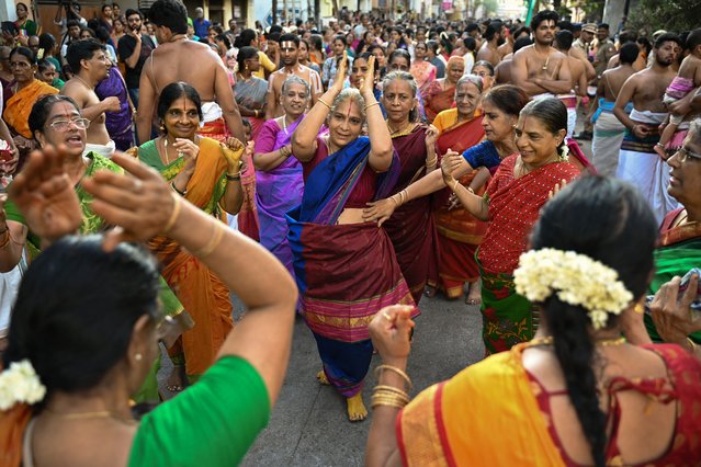 Devotees chant religious hymns while taking part in a chariot festival of Sri Parthasarthy Swamy temple in Chennai on April 29, 2024. (Photo by R. Satish Babu/AFP Photo)