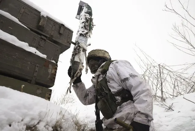 An Ukrainian serviceman checks the situation at the positions on a front line, not far from pro-Russian militants controlled city of Donetsk, Ukraine, 29 January 2022. Russia has recently strengthened its groups near the border with Ukraine and Belarus, with no signs of de-escalation, Pentagon spokesman John Kirby said on 24 January 2022. (Photo by Stas Kozlyuk/EPA/EFE)