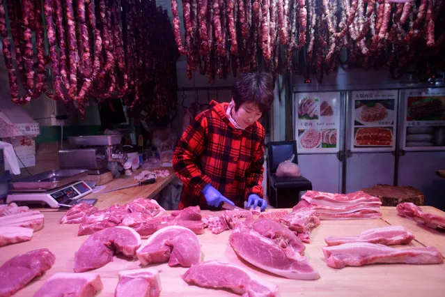 A vendor cuts meat at a market in Beijing, China, January 10, 2017. (Photo by Jason Lee/Reuters)