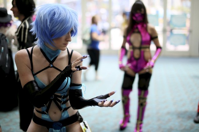 Cosplay attendees pose for pictures at the 2015 Comic-Con International in San Diego, California, July 9, 2015. (Photo by Sandy Huffaker/Reuters)