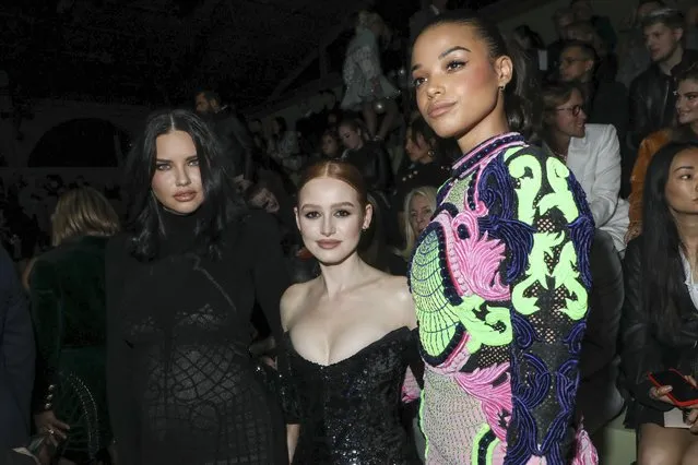 Brazilian model Adriana Lima, from left, American actress and YouTuber Madelaine Petsch and English actress Ella Balinska attend the Balmain Ready To Wear Fall/Winter 2022-2023 fashion collection, unveiled during the Fashion Week in Paris, Wednesday, March 2, 2022. (Photo by Vianney Le Caer/Invision/AP Photo)
